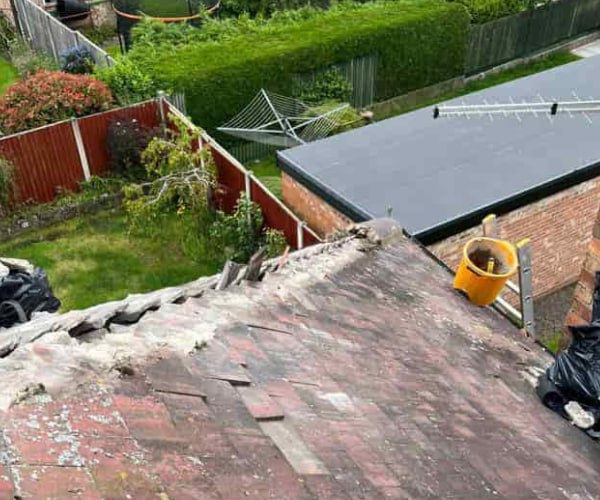 This is a photo of a roof hip that is having the hip (or bonnet) tiles replaced. Works carried out by SC Roofing Olney