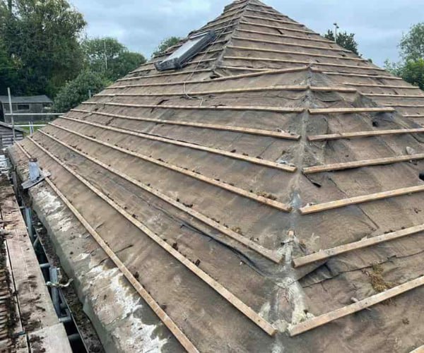 This is a photo of a hip roof that has been stripped back to the battens, and is awaiting a new roof covering to be installed. Works carried out by SC Roofing Olney